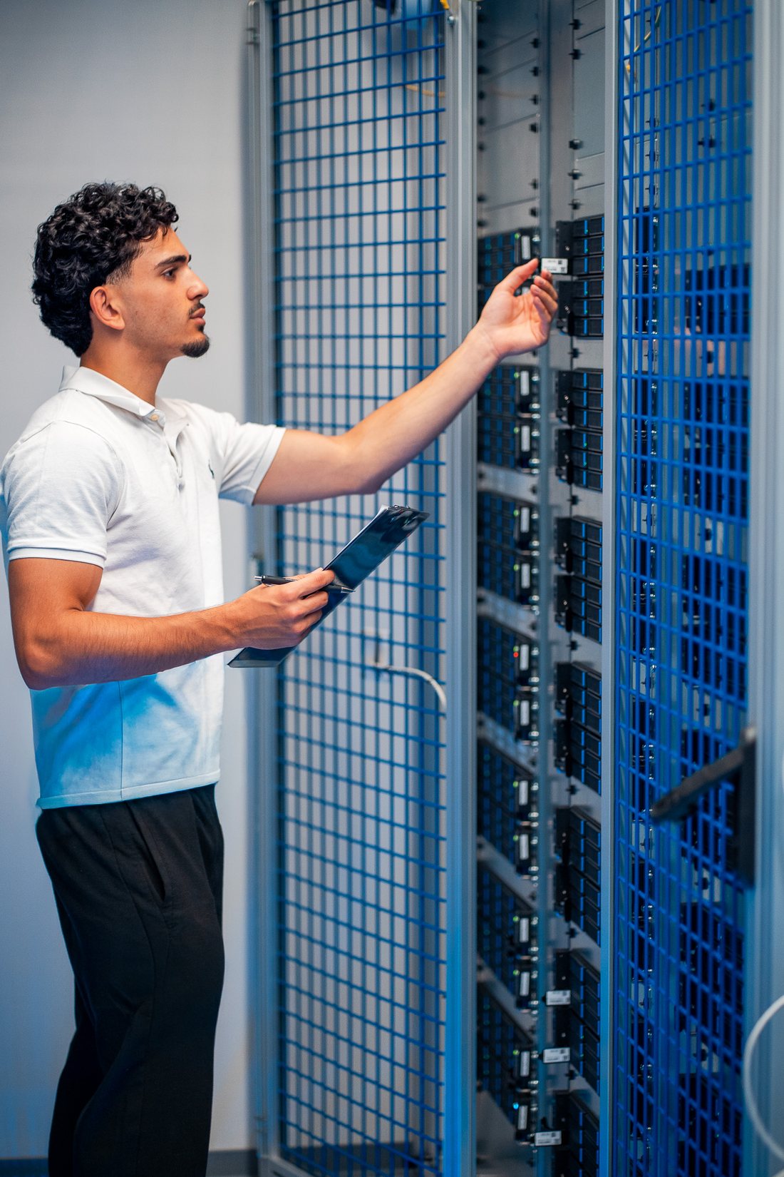 Abdulaziz Albunni inspecting servers in an enterprise rack